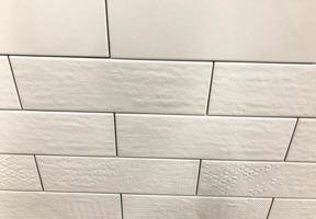 decorative brick for wall covering, texture. white brick tiles, bath and shower covering. slippery, smooth marble surface photo