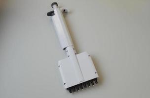 mechanical dispenser for setting test tubes and performing research in laboratory conditions. laboratory diagnostic tool. blood tests from a vein photo