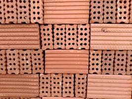 An orderly stack of bricks on a construction site. photo