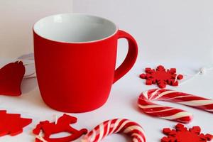 Blank red mug isolated on white background,mat tea or coffee cup with christmas and new year decoration,mock up with ceramic mug for hot drinks,empty gift print branding template,tankard for design. photo