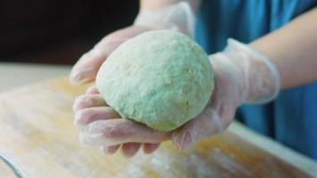 The chef spreads the green dough with a rolling pin. Tortillas prepared and decorated with spinach and beets. Red and green tortillas video