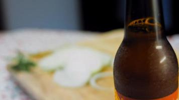 Glass with fresh and sparkling beer. In the background is a romantic atmosphere with lights video