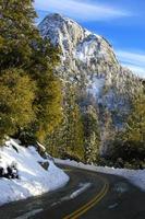 Windy mountain road with snow and ice looking at Mt. Tahquitz in Idyllwild, California. photo