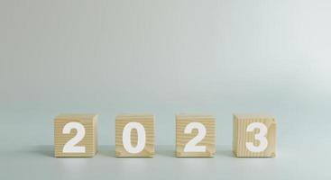 Happy new year 2023, horizontal wood blocks cube or square with number 2023 on white background. New year 2023 concept.3d rendering. with copy space. photo