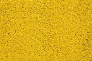 Painted yellow stone wall for texture background. photo