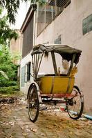 Traditional Thai transport - old yellow trishaw on a street. Chiang Mai, Thailand. photo