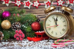 reloj de navidad y rama de abeto foto