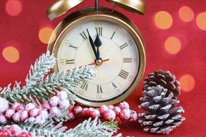 Christmas snow fir tree, alarm clock and gift bag on red background. photo