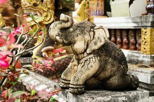 Stone sculpture of elephant near to Thai Buddhist temple. Chiang Mai, Thailand. photo