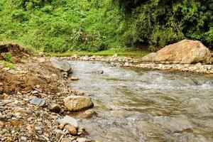 View on a mountain river with stony banks in rainforest. Chiang Dao, Thailand. photo