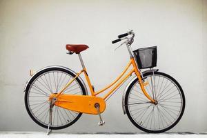 Bicycle on a background of painted white wall on a street. photo