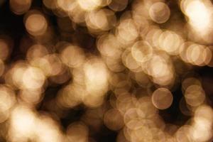 Blurred circles yellow color on a black background. Abstract background. photo