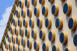 Travel to Bangkok, Thailand. The fragment of a building with round windows. photo