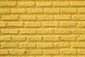 Yellow wall from bricks for background. photo