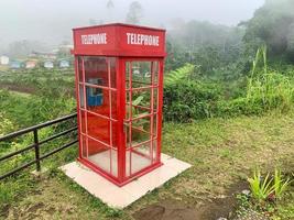 A classic British red telephone booth tucked away in the mountains photo