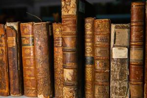 Very old books sitting on the shelves in the library. Books as a symbol of knowledge. photo