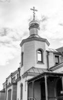 Christian church cross in high steeple tower for prayer photo