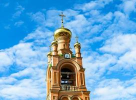 Christian church cross in high steeple tower for prayer photo