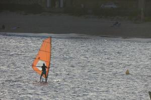 practicing windsurfing in the mediterranean sea, calm sea photo