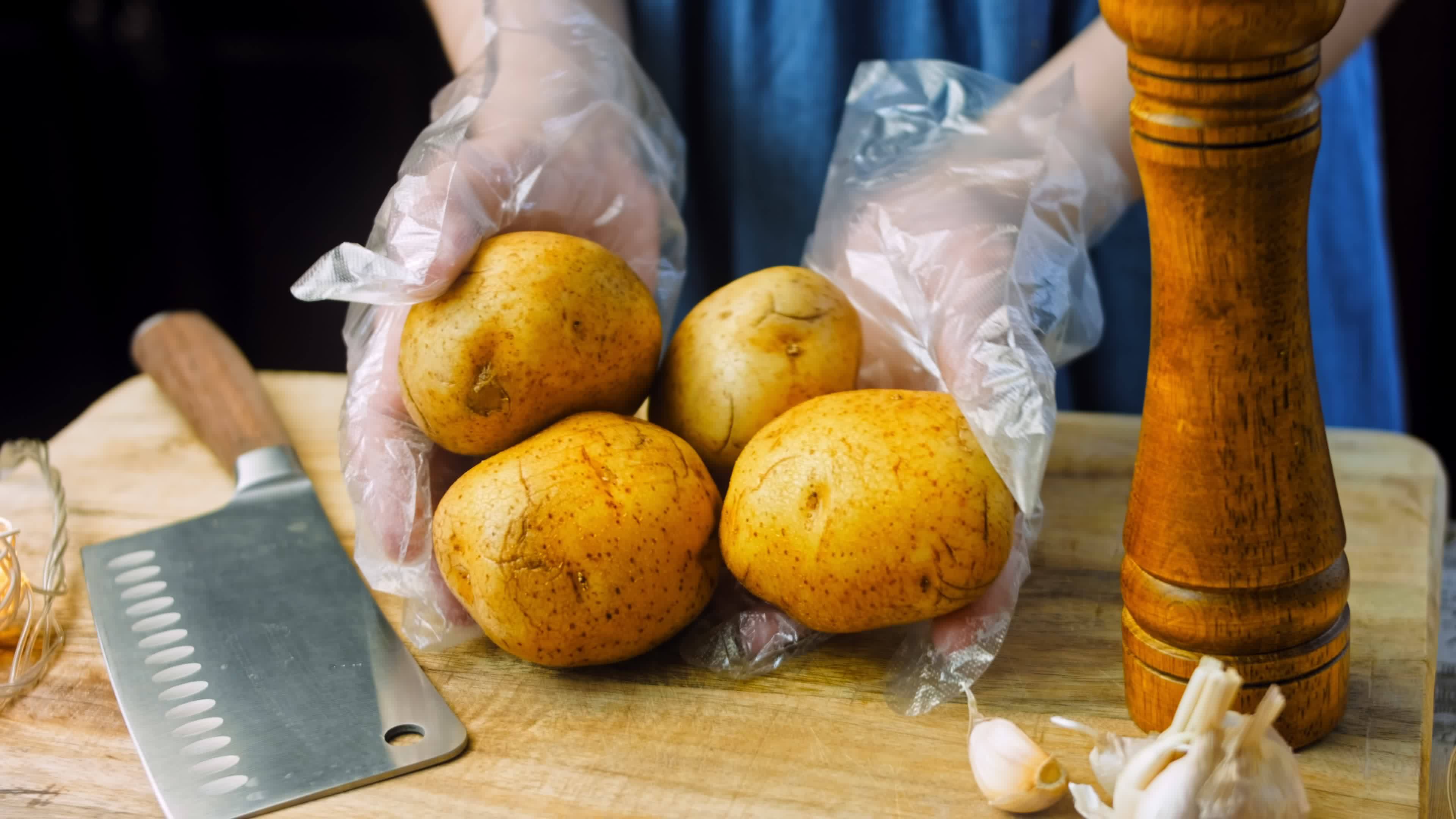 Boil the potatoes in an iron bowl. Macro shooting on intense steam