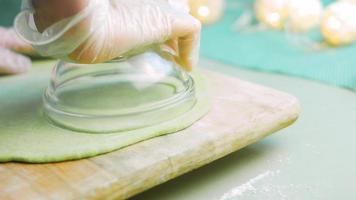 The chef spreads the green dough with a rolling pin. Tortillas prepared and decorated with spinach and beets. Red and green tortillas video