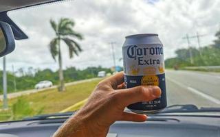 Playa del Carmen Quintana Roo Mexico 2022 Corona Beer can in hand while driving a car Mexico. photo