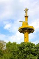 Yellow light house watchtower observation tower in nature in Germany. photo
