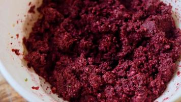 The girl tastes pkhali. Pkhali traditional Georgian food. Beetroot is used for the purple color. Walnut is used for decoration video