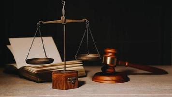 Justice and law concept.Male judge in a courtroom with the gavel, working with, computer and docking keyboard, eyeglasses, on table in morning light video