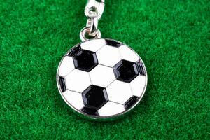 Key holder with a soccer ball in hand photo
