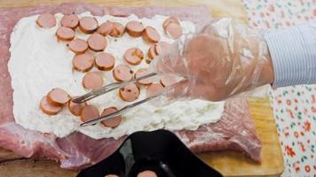 The chef puts the sausage slicers with food tongs video