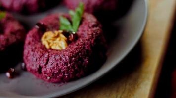 The girl tastes pkhali. Pkhali traditional Georgian food. Beetroot is used for the purple color. Walnut is used for decoration video