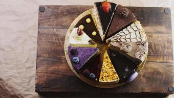 Ten kinds of cakes on a golden tray and on a wooden tray with decorations video