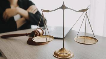 Justice and law concept.Male judge in a courtroom with the gavel, working with, computer and docking keyboard, eyeglasses, on table in morning light video