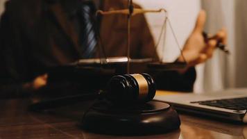 Justice and law concept.Male judge in a courtroom with the gavel, working with, computer and docking keyboard, eyeglasses, on table in morning light video