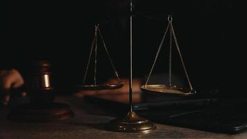 Business and lawyers discussing contract papers with brass scale on desk in office. Law, legal services, advice, justice and law video