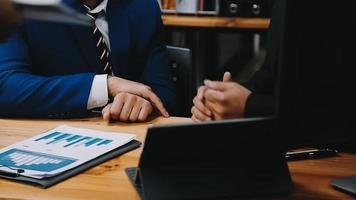 Businessman working with smart phone and laptop and digital tablet computer in office with digital marketing media in virtual icon video