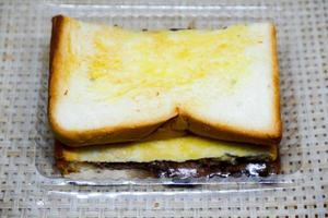 Selective focus of chocolate jam toast in a plastic container. photo