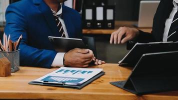 Businessman working with smart phone and laptop and digital tablet computer in office with digital marketing media in virtual icon video