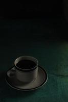 Cup of coffee on green background photo