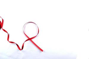 Red Support Ribbon isolated on white background. World aids day and national HIV AIDS and aging awareness month with red ribbon. copyspace area photo