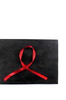 red aids ribbon on old wood background photo