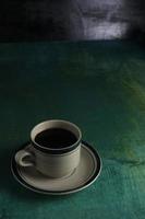 Cup of coffee on green background photo