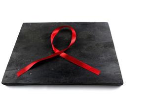 red aids ribbon on old wood background photo