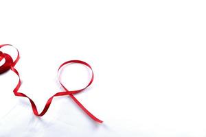 Red Support Ribbon isolated on white background. World aids day and national HIV AIDS and aging awareness month with red ribbon. copyspace area photo