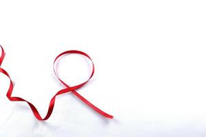 Red Support Ribbon isolated on white background. World aids day and national HIV AIDS and aging awareness month with red ribbon. copyspace area photo