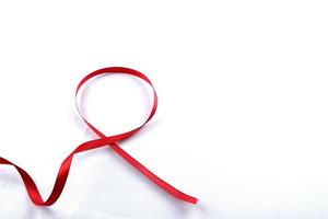 Red Support Ribbon isolated on white background. World aids day and national HIV AIDS and aging awareness month with red ribbon. copyspace area photo