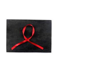 Cinta roja del SIDA sobre fondo de madera vieja foto