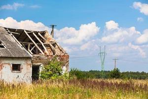 Abandoned farm house in a field photo