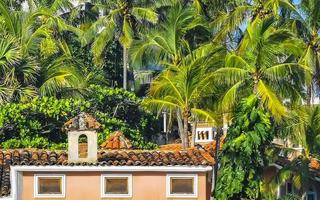 Hotels resorts buildings in paradise among palm trees Puerto Escondido. photo